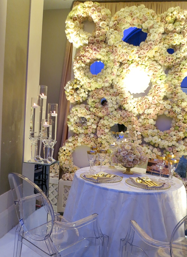 A graphic yet ethereal flower wall made of round wreaths, from FOS Decor Center. Bold Floral and Floral Cake Ideas from the Wedluxe Show 2015. For more ideas, visit Rebecca Chan Weddings and Events at rebeccachan.ca