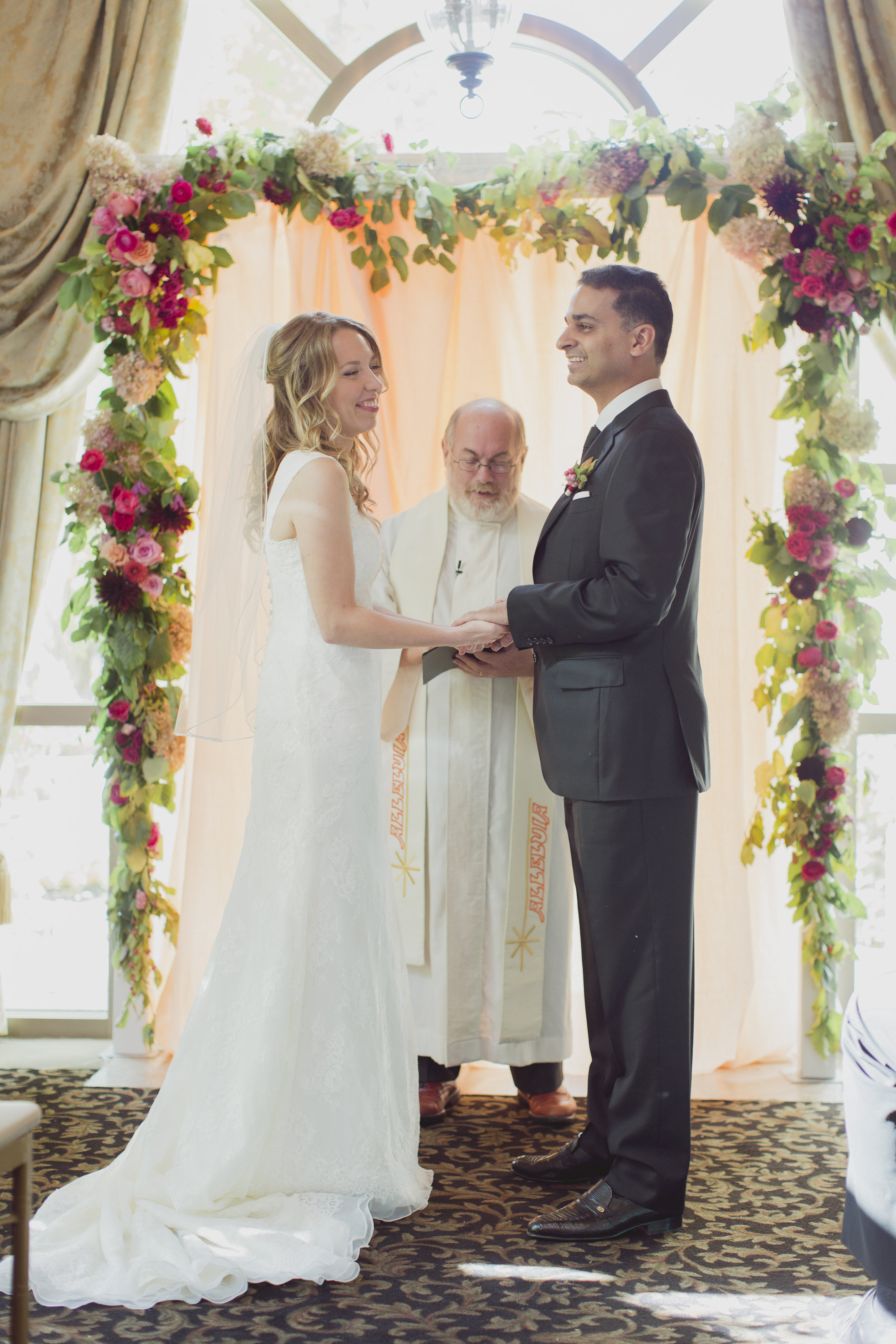 Cranberry and peach floral garland at the wedding ceremony. See more at Rebecca Chan Weddings and Events https://rebeccachan.ca