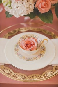 Cute floral tea cups on gold chargers. Coral and Gold Wedding Inspiration - See more at Rebecca Chan Weddings and Events rebeccachan.ca