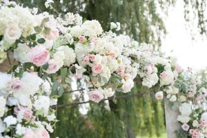 Blush Pink Ontario Winery wedding - Intimate ceremony with lush floral garland arch
