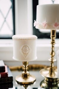 Estates of Sunnybrook indoor ceremony inspiration - brass candlesticks and mini cakes