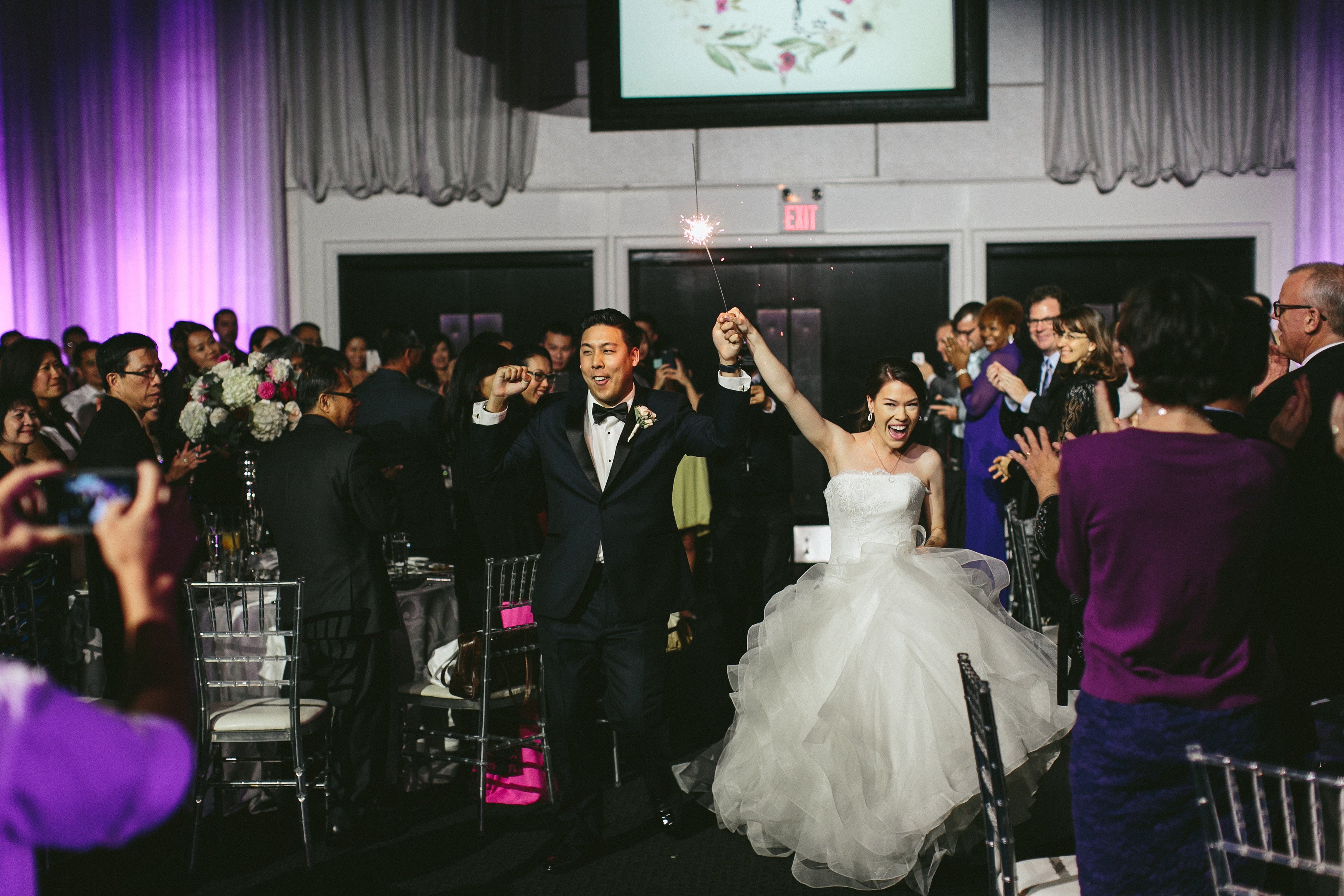 Sophisticated Garden-Inspired Wedding in Toronto at the Grand Luxe - bride and groom entrance with sparkler