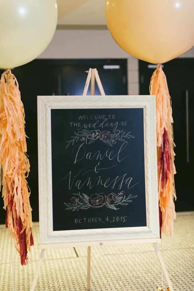 Wedding Day Stationary idea from a Sophisticated Garden-Inspired Wedding in Toronto at the Grand Luxe - Modern Chalk Calligraphy sign with big balloons