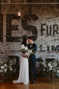 Intimate Burroughes Building wedding with string lights and lavender