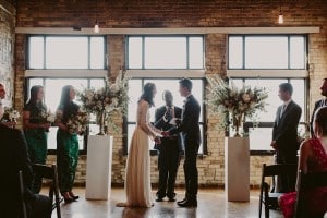 Ceremony - Intimate Burroughes Building wedding with string lights and lavender
