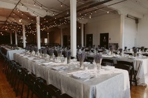 Intimate Burroughes Building wedding with string lights and lavender
