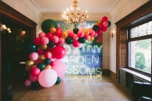 Private party for Rupi Kaur - jewel toned balloon spill