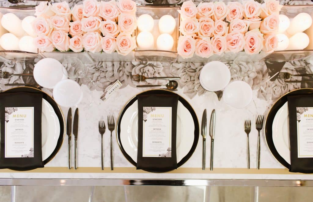 Modern and masculine corporate tabletop design with pink roses and vinyl