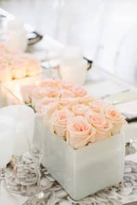 Modern and masculine corporate tabletop design with pink roses and vinyl