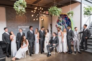 Modern Industrial Wedding Ceremony with Wall Vinyl and Hanging String Lights at District28
