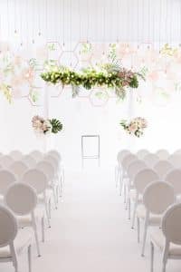 Modern Industrial Wedding Ceremony with Wall Vinyl and Hanging String Lights at District28