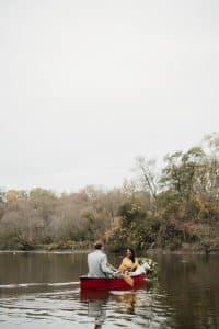 Romantic engagement shoot in a canoe with a dog