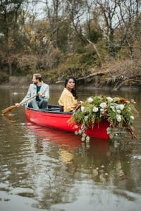 Romantic engagement shoot in a canoe with a dog