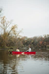 Romantic engagement shoot in a canoe with a dog