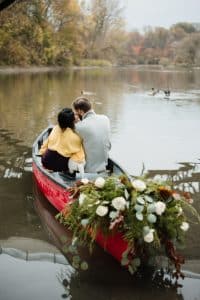 Romantic engagement shoot in a canoe with a dog