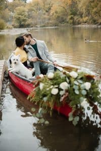 Romantic engagement shoot in a canoe with a dog