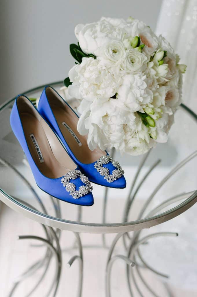 White bridal bouquet and blue Manolo Blahnik shoes.