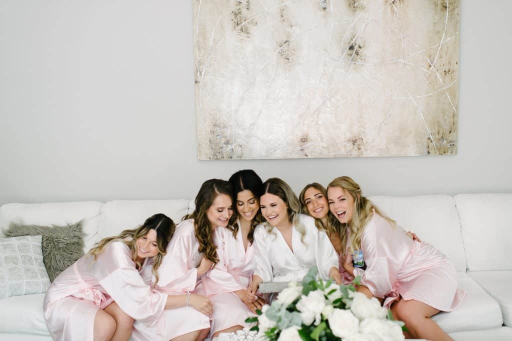 Bride and her bridesmaids in blush robes.