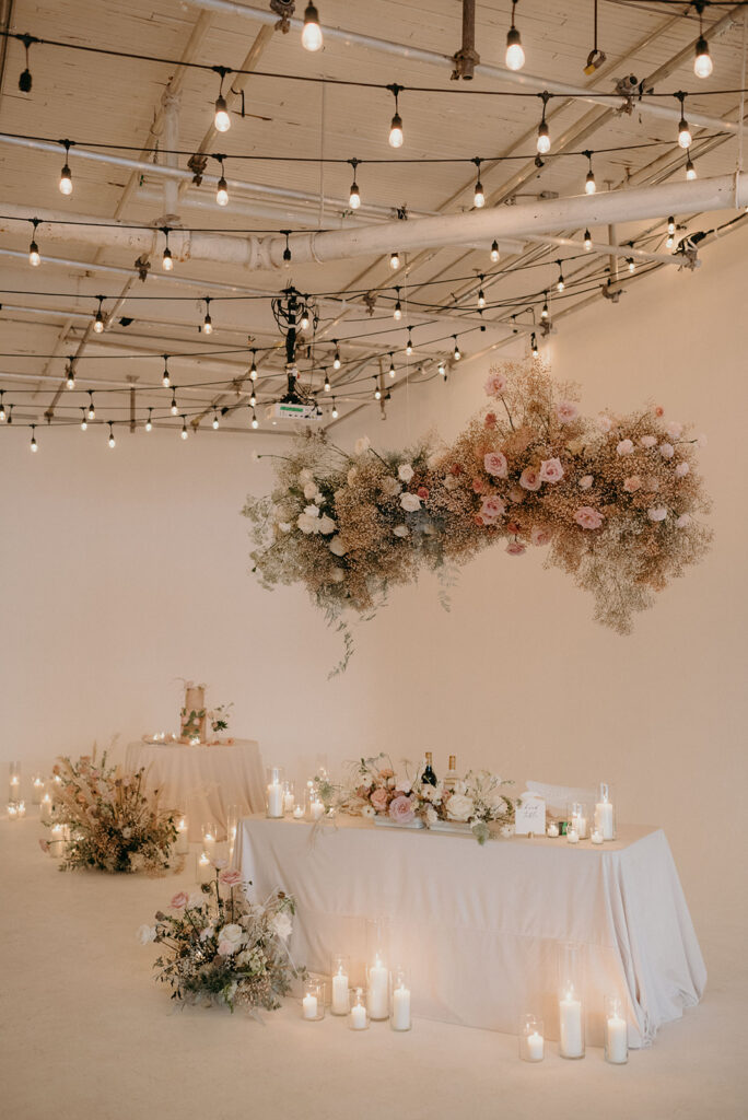 Head table floating in the clouds. Whimsical and dreamy cloud wedding at District 28. Planning by Rebecca Chan Weddings & Events rebeccachan.ca