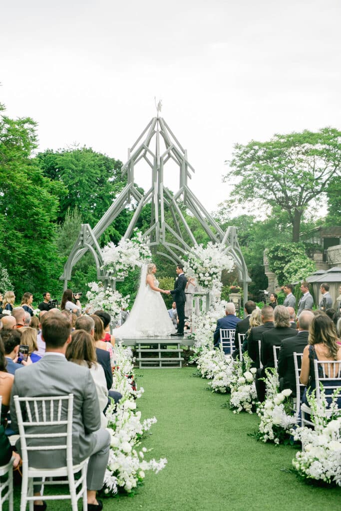 Classic Casa Loma Wedding Ceremony with white roses. Planned by Rebecca Chan Weddings & Events