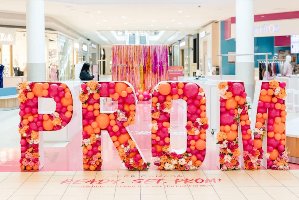 Balloons and flowers in PROM marquee letters at Upper Canada Mall