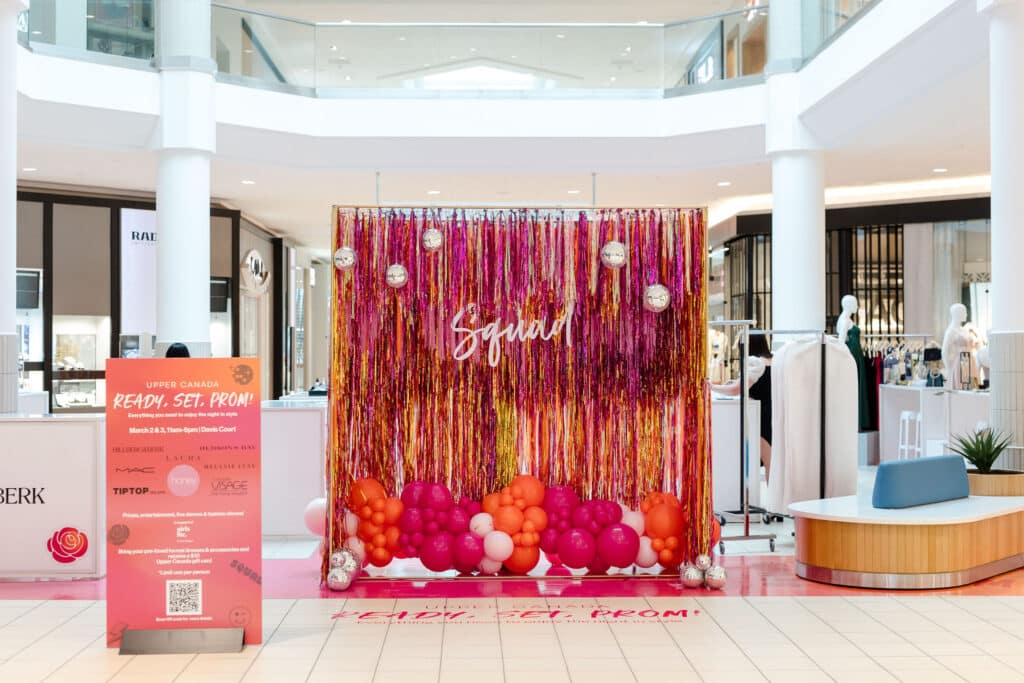 Custom made pink and orange fringe backdrop with disco balls and balloons - Prom pop up at Upper Canada Mall