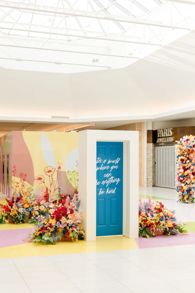 Kindness Garden mall activation with positive messages on doors at Oshawa Centre