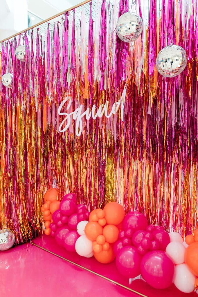 Prom decor idea: Custom made pink and orange fringe backdrop with disco balls and balloons - Prom pop up at Upper Canada Mall