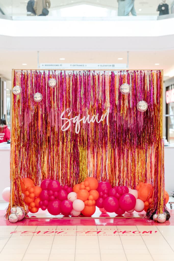 Prom decor idea: Custom made pink and orange fringe backdrop with disco balls and balloons - Prom pop up at Upper Canada Mall