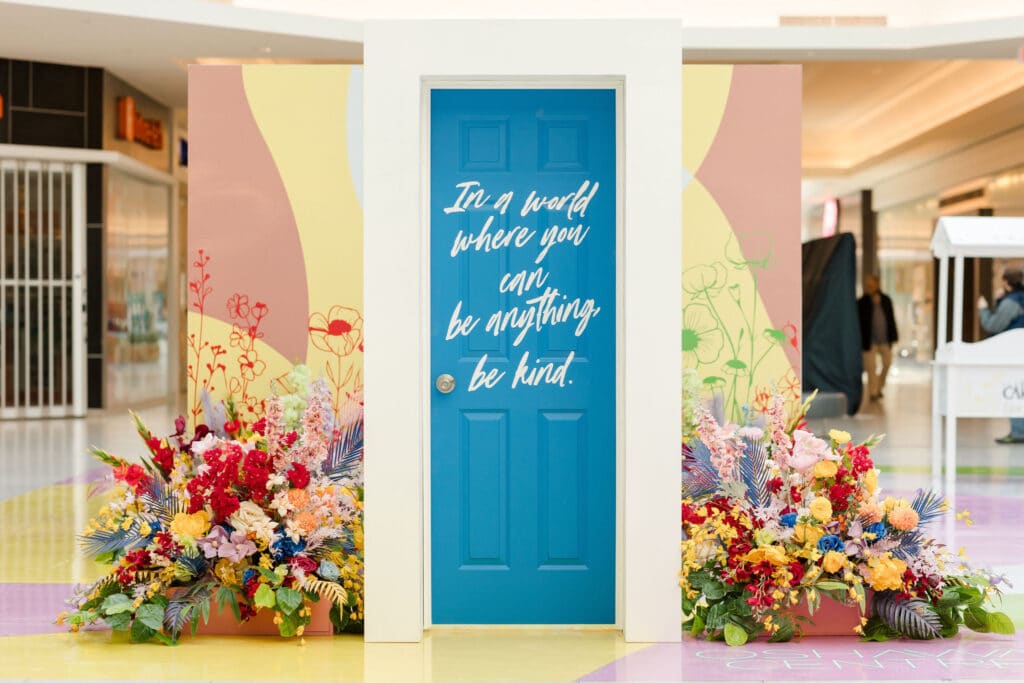 Kindness Garden mall activation with positive messages on doors at Oshawa Centre