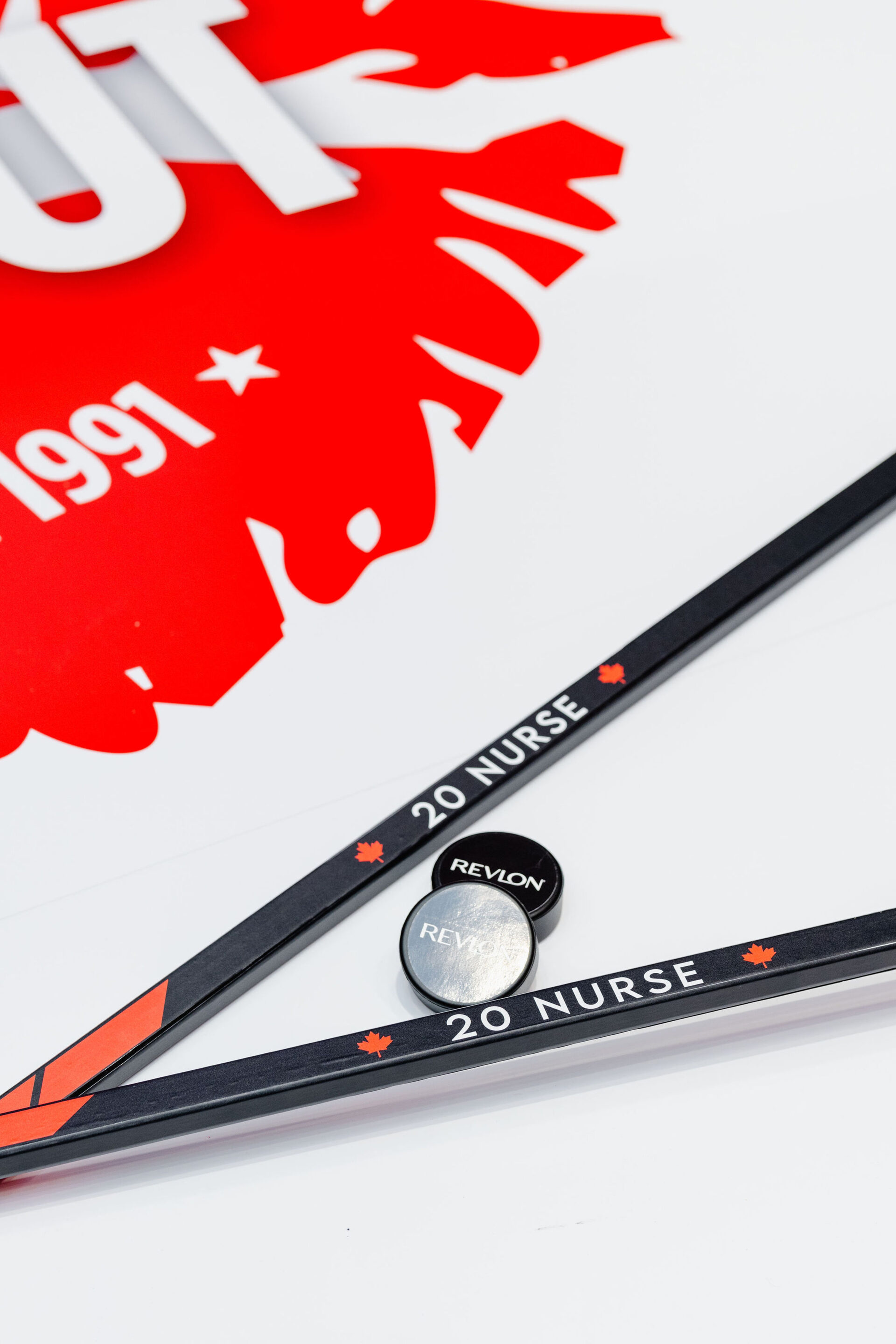 Custom branded hockey sticks and branded hockey puck for Revlon ColorStay Brand Activation 