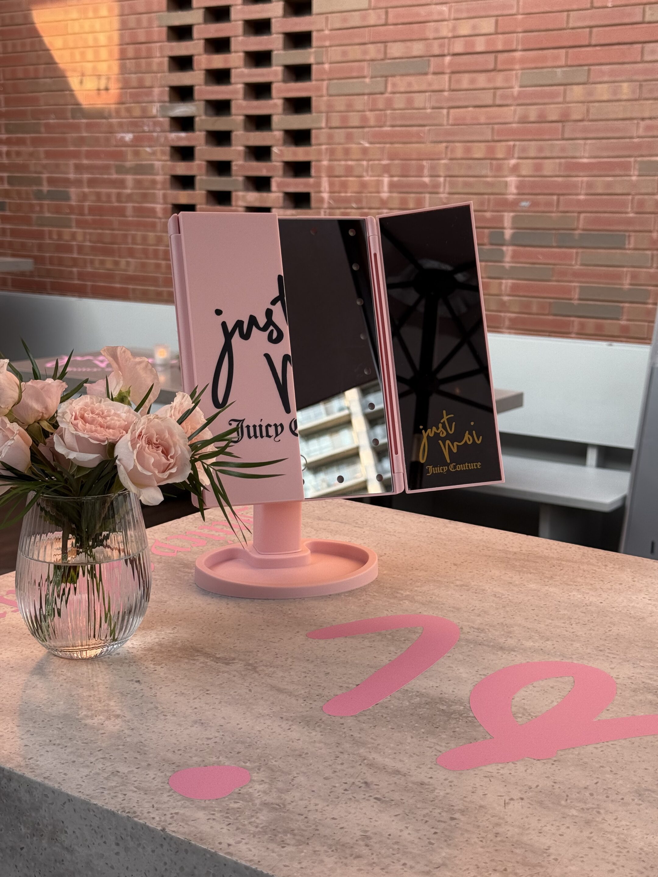 Juicy Couture Just Moi fragrance brand activation - pink floral and branded mirror